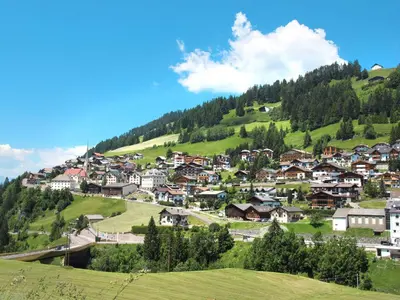 a village on a green hill with houses at Apartment Ornella-2 by Interhome in Santa Cristina in Val Gardena