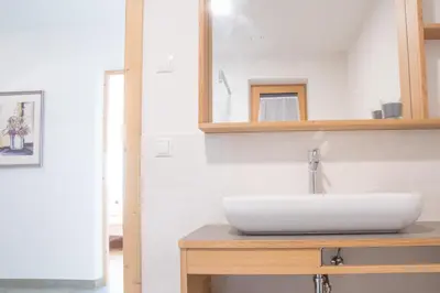 a bathroom with a white sink and a mirror at Tschott Hof in Villandro