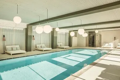 a large swimming pool with chandeliers at Engel Gourmet&Spa in Nova Levante