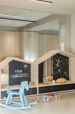 a toy room with a toy horse and a chair at Engel Gourmet&Spa in Nova Levante