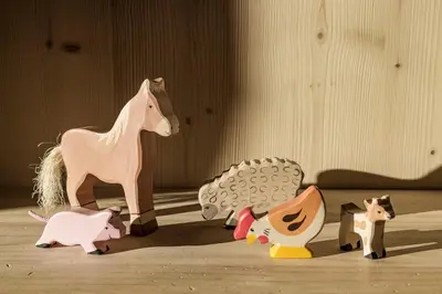 a group of wooden toy animals on the floor at Engel Gourmet&Spa in Nova Levante
