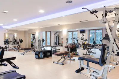 a gym with a lot of treadmills and exercise equipment at Engel Gourmet&Spa in Nova Levante
