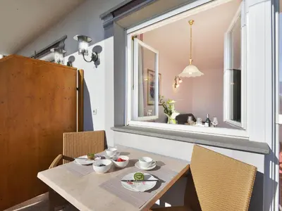 a table on a balcony with a view of mountains at Apartment Comfort 202 by Interhome in Villandro