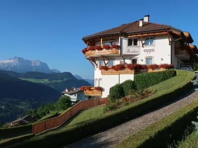 a house on a hill with a green yard at Apartment Comfort 301 by Interhome in Villandro