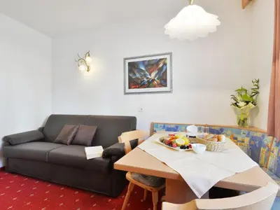 a bedroom with a bed and a room with a window at Apartment Comfort 301 by Interhome in Villandro