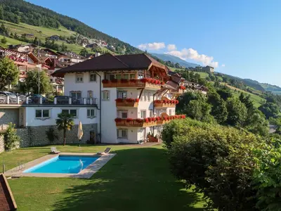 a house on a hill with snow on the ground at Apartment Classic 303 by Interhome in Villandro