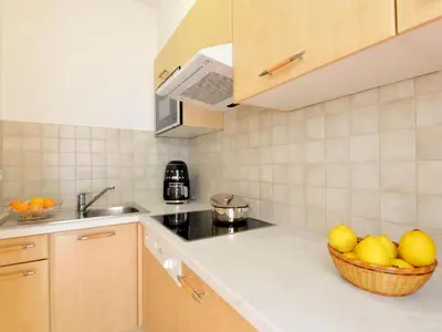 a kitchen with a basket of fruit on the counter at Apartment Classic 303 by Interhome in Villandro