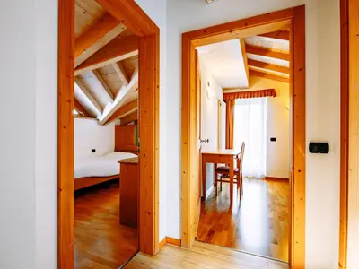 a bathroom with a wooden door and a sink at Apartment Belfiore-1 by Interhome in Ronzone