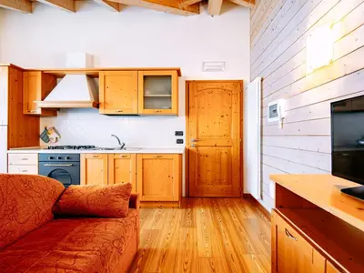 a kitchen with a table with a bowl of fruit on it at Apartment Belfiore-2 by Interhome in Ronzone