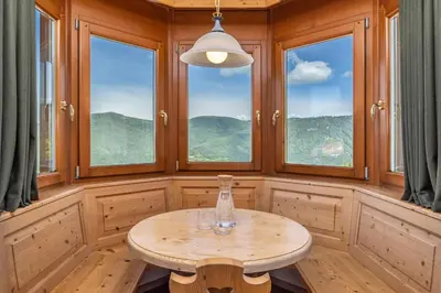 a room with a table and some windows at Hotel Tirol- Natural Idyll in Montesover