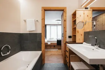 a bathroom with two sinks and a bath tub at Lagació Hotel Mountain Residence in San Cassiano