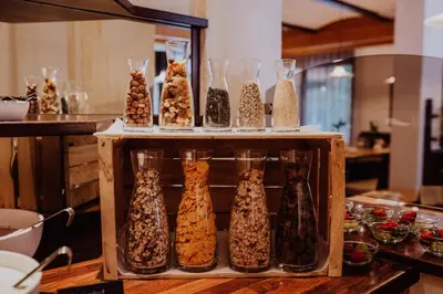 a display of glass vases filled with food at Martinerhof's Brauhotel in San Martino
