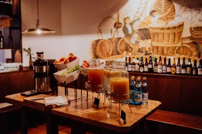 a bar with two glasses of drinks on a wooden table at Martinerhof's Brauhotel in San Martino