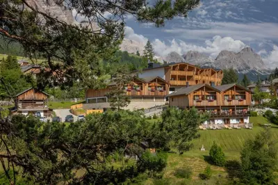 a large building in the middle of a mountain at Hotel Rezia in La Villa