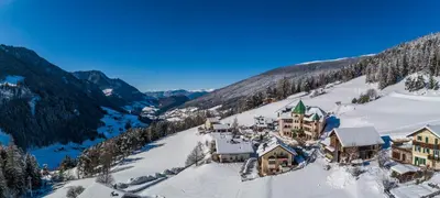 an aerial view of a resort on a snowy mountain at Hotel Ansitz Jakoberhof in Ortisei