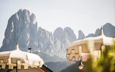 a view of a mountain range with two buildings at Hotel Ansitz Jakoberhof in Ortisei