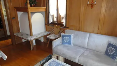 a living room with a couch and two chairs at Sweet Home in Cortina dʼAmpezzo