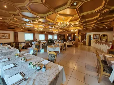 an overhead view of a restaurant with tables and chairs at Albergo Scoiattolo in Falcade