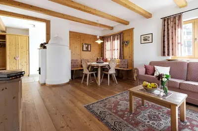 a living room with a couch and a table at Pineta Natural Chalet in Coredo