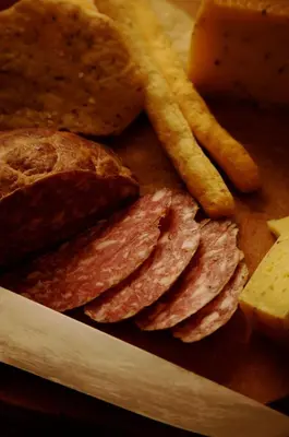 a plate of food with crackers and bread and french fries at Pineta Natural Chalet in Coredo