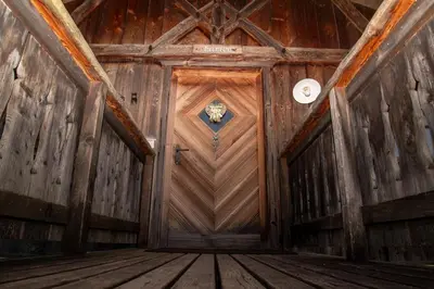 an inside view of a wooden door in a building at Pineta Natural Chalet in Coredo