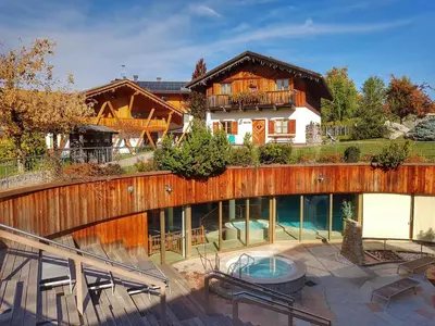 a house with a swimming pool in front of it at Pineta Natural Chalet in Coredo