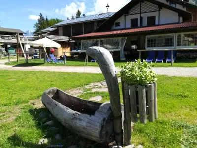 a statue of a boat sitting in the grass at Agritur le Vale in Fiera di Primiero