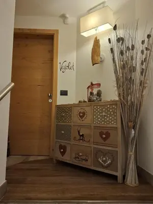 a room with a dresser and a door at Majon de la nona in Pozza di Fassa
