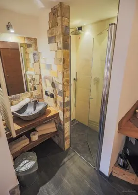 a bedroom with a bed with a large picture on the wall at Majon de la nona in Pozza di Fassa