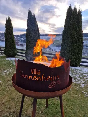 a fire pit with the words villa tannenberg at Villa Tannenheim in Castelrotto