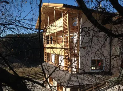 a building under construction with its lights on at Villa Tannenheim in Castelrotto