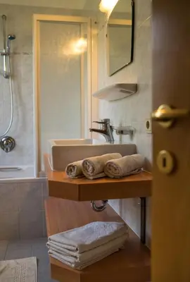 a bathroom with a sink and a counter with towels at Villa Tannenheim in Castelrotto
