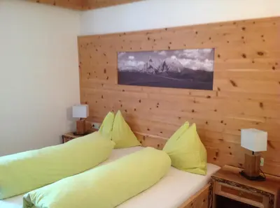 a room with two beds with yellow pillows at Villa Tannenheim in Castelrotto