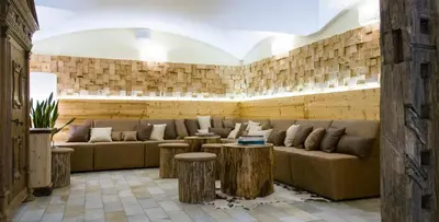 a living room with a couch and two tables at Christophs Hotel in Schenna