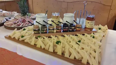 a buffet of food on a table with food at Hotel El Mondin in Fiera di Primiero