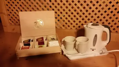 a box with a coffee maker and cups on a table at Hotel El Mondin in Fiera di Primiero