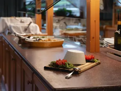 a kitchen counter with a cutting board with vegetables on it at Berg Hotel Latemar Spitze in Vigo di Fassa