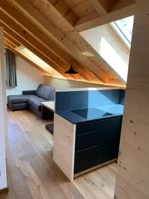 a room with a kitchen and a living room at Villa sulla passeggiata in Ortisei