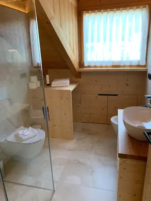 a bathroom with a toilet and a sink at Villa sulla passeggiata in Ortisei