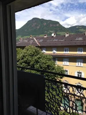 a balcony with a view of a building and a mountain at Apartment G.Verdi in Bolzano