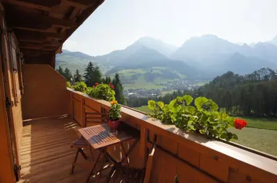 a balcony with a table and a view of mountains at Ciasa Pedaga in San Vigilio Di Marebbe