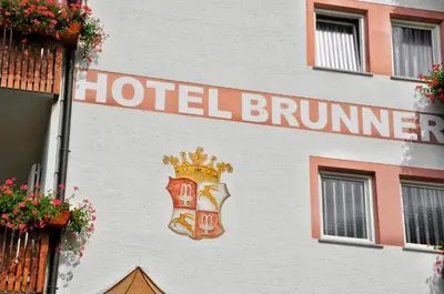 a hotel burns sign on the side of a building at Hotel Brunner in Merano