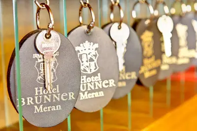 a row of key tags on a rack withoons at Hotel Brunner in Merano