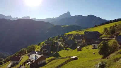 a village on a hill with mountains in the background at Sumaela Apartments in La Valle