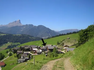 a small village on a hill with mountains in the background at Sumaela Apartments in La Valle