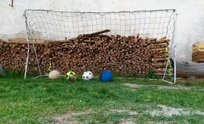 a pile of wood next to a soccer ball and a goal at Sumaela Apartments in La Valle