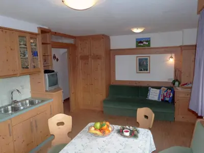 a kitchen with a table with a bowl of fruit on it at Sumaela Apartments in La Valle