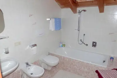 a bathroom with a toilet and a tub and a sink at Sumaela Apartments in La Valle