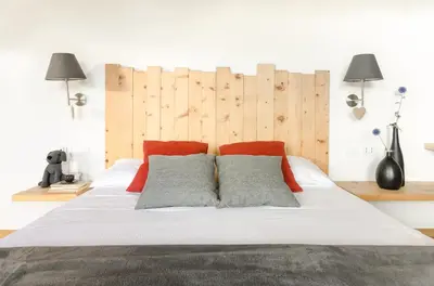 a bedroom with a large bed with two pillows at B&B Lupo in Cavareno