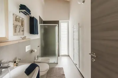 a bathroom with a toilet and a sink and a shower at B&B Lupo in Cavareno